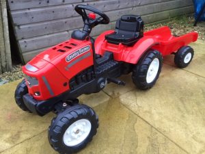 Red country farmer tractor ride on toy, with trailer