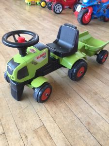 Small green Klass tractor ride on toy with trailer