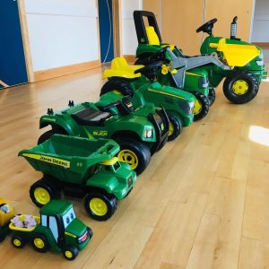 a collection of tractors and farm vehicles, all in green