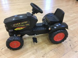 Black tractor ride on toy with Farm King logo