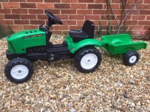 green tractor ride on toy with trailer